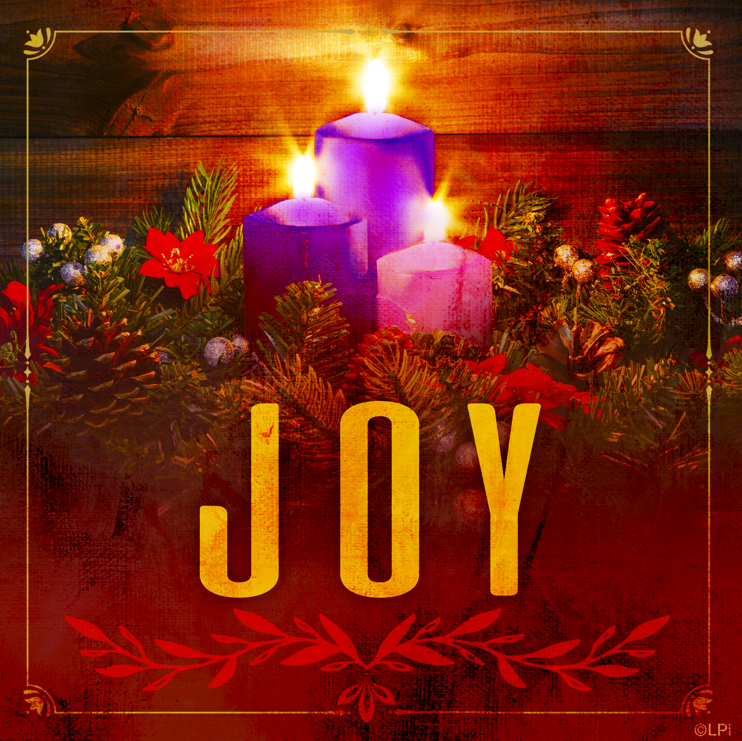 Three lit candles on the Advent wreath with the word JOY