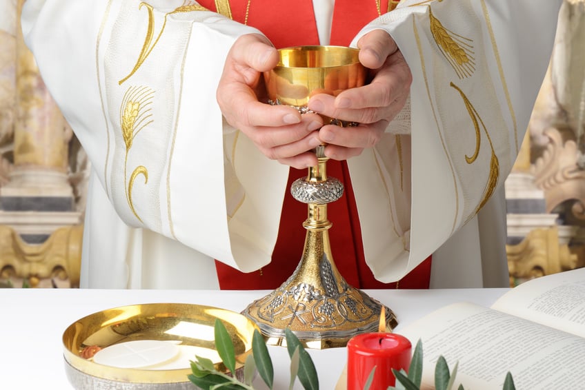 Photo of a priest's hands holding a chalice at the altar