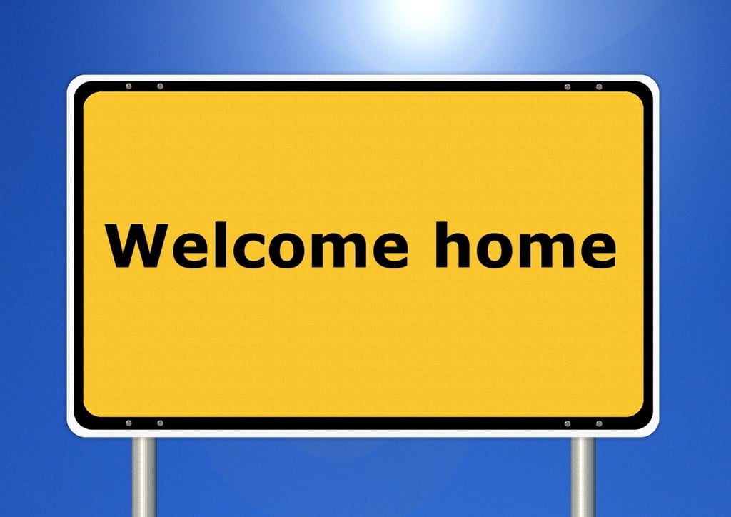 Street sign with the words welcome home