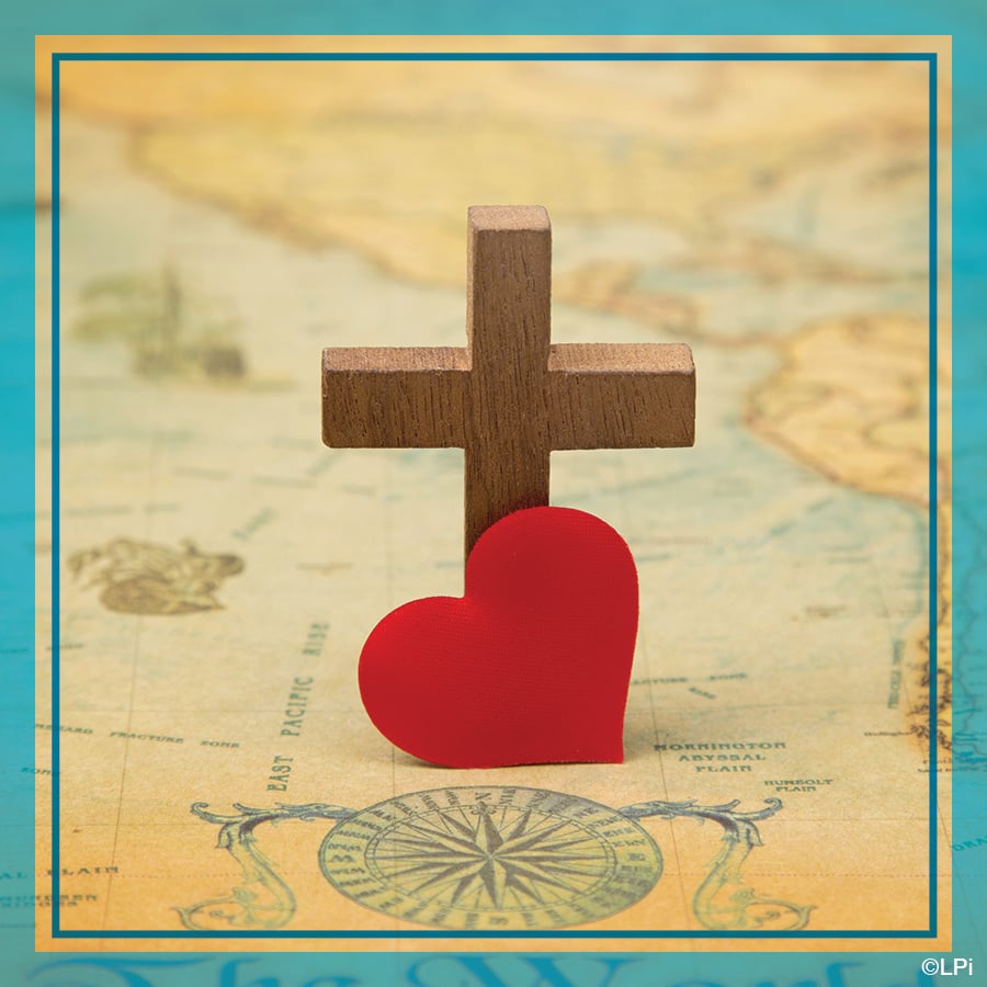 Photo of a cross and heart on a map