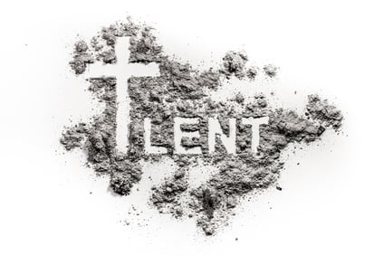 Photo of a cross and the word LENT drawn in ashes