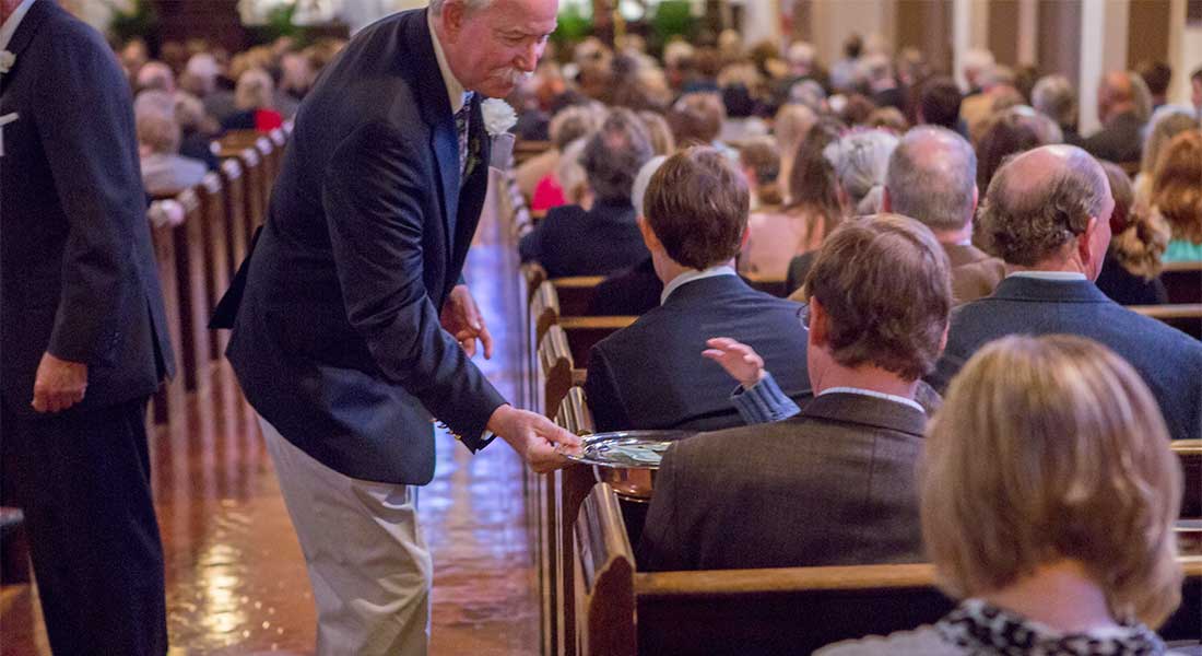 Photo of an usher taking collection