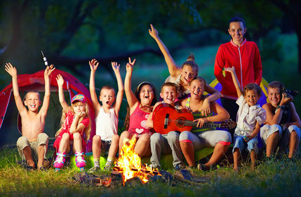 Photo of children sitting around a campfire