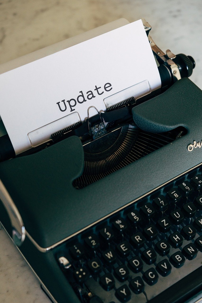 Photo of a typewriter with the word "Update" typed on the paper