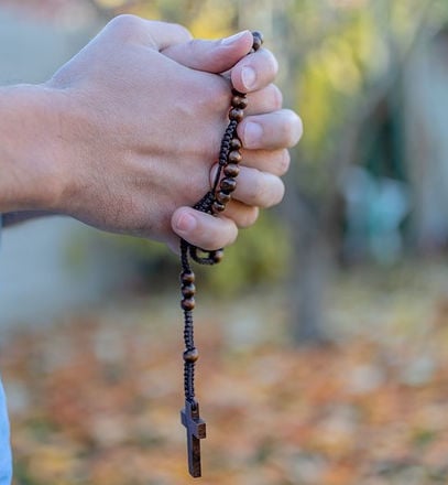 praying hands and rosary